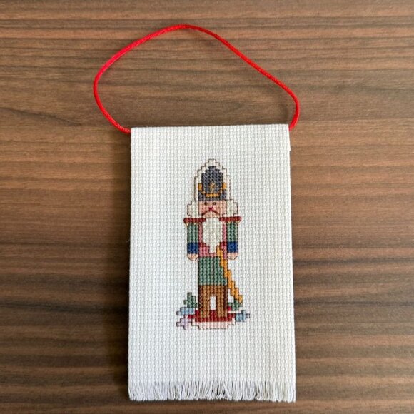 Vintage Handmade Cross-Stitch Nutcracker Ornament With Red Hanging Loop - Picture 3 of 7